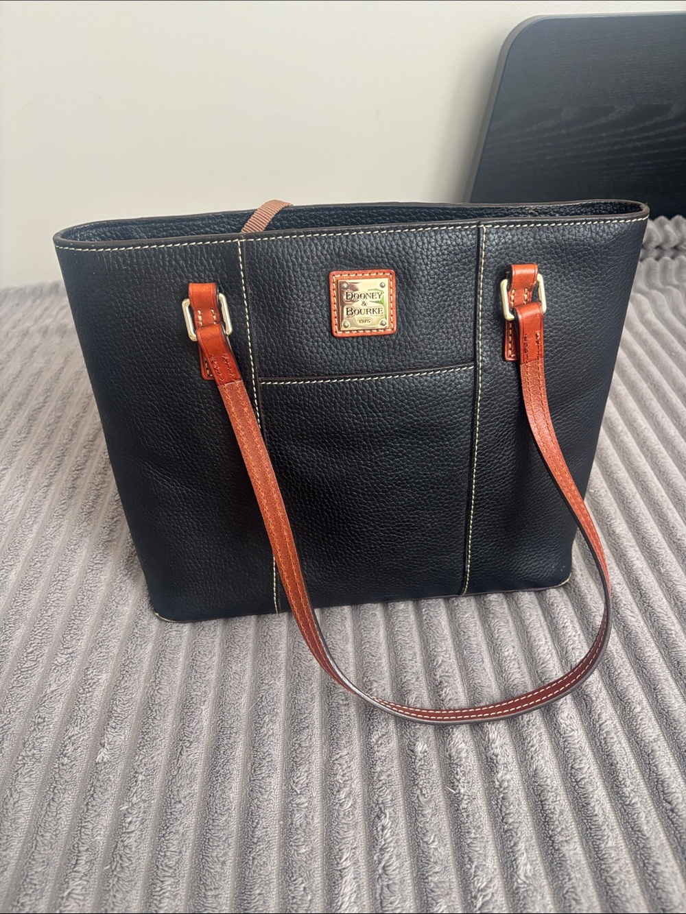 Dooney & Bourke Black Pebble Leather Tote with Brown Straps and Gold Plaque
